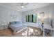 Sun-lit bedroom with a ceiling fan, large window, and desk space at 1966 Freedom Dr, Clearwater, FL 33755