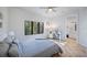 Bright bedroom featuring a ceiling fan, large window and an ensuite bathroom at 1966 Freedom Dr, Clearwater, FL 33755