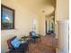Inviting covered front porch with comfortable seating, elegant columns, and serene outdoor views at 1966 Freedom Dr, Clearwater, FL 33755