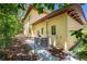 Side exterior view of a beautiful yellow home with an AC unit and fenced-in yard at 1966 Freedom Dr, Clearwater, FL 33755