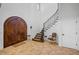 Grand foyer featuring a striking staircase, tile floors, and an impressive wooden double door entrance at 1966 Freedom Dr, Clearwater, FL 33755