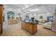 Spacious kitchen adjacent to living room offers a granite island, ample cabinets, and seamless flow for entertaining at 1966 Freedom Dr, Clearwater, FL 33755