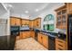 Well-equipped kitchen features custom wood cabinetry, granite countertops, and modern appliances at 1966 Freedom Dr, Clearwater, FL 33755