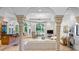 Bright living room with tiled floor, ornate columns, arched windows, and comfortable seating creates a welcoming atmosphere at 1966 Freedom Dr, Clearwater, FL 33755