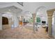 Open-concept living room with pillars, neutral furniture, and tile flooring leading to the kitchen area at 1966 Freedom Dr, Clearwater, FL 33755