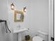 Comfortable powder room with pedestal sink and decorative mirror at 1966 Freedom Dr, Clearwater, FL 33755