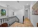 Elegant staircase with wrought iron railing and decorative chandelier at 1966 Freedom Dr, Clearwater, FL 33755