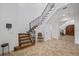 Elegant staircase with carpeted steps, iron railing, and a glimpse of a mirrored door in the foyer at 1966 Freedom Dr, Clearwater, FL 33755