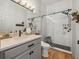 Bathroom featuring a large mirror, gray vanity, and glass enclosed shower with black hardware at 19808 Sunsplash Ln, Lutz, FL 33558