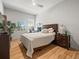 Bedroom with a bed, bedside table, lamp, and a colorful piece of wall art at 19808 Sunsplash Ln, Lutz, FL 33558
