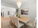 Open dining area with modern chandelier and picture with a bridge at 19808 Sunsplash Ln, Lutz, FL 33558