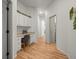 Hallway with built-in cabinetry, a desk and chair in neutral colors at 19808 Sunsplash Ln, Lutz, FL 33558