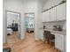 Hallway featuring built-in cabinets and a desk, with views into the bedrooms at 19808 Sunsplash Ln, Lutz, FL 33558