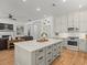 Kitchen island with bar stools offering an open design to the living room and dining area at 19808 Sunsplash Ln, Lutz, FL 33558