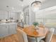 Charming kitchen with gray cabinets, stainless steel appliances, and a breakfast nook with a chandelier at 19808 Sunsplash Ln, Lutz, FL 33558