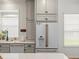 Kitchen features stainless steel appliances, white cabinets, and stylish modern copper hardware at 19808 Sunsplash Ln, Lutz, FL 33558