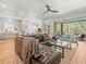 Spacious living area featuring tile floors, open layout, with modern furniture and access to outdoor patio at 19808 Sunsplash Ln, Lutz, FL 33558