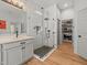 Bathroom featuring a glass-enclosed shower, a single vanity, and access to a walk-in closet at 19808 Sunsplash Ln, Lutz, FL 33558
