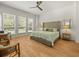 Serene main bedroom featuring hardwood floors, lots of natural light, and a ceiling fan at 19808 Sunsplash Ln, Lutz, FL 33558
