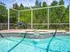 Spa waterfall feature in enclosed pool provides a relaxing, private outdoor living space at 19808 Sunsplash Ln, Lutz, FL 33558