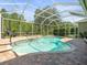 Enclosed pool with a spa and brick patio offers a private outdoor retreat at 19808 Sunsplash Ln, Lutz, FL 33558