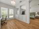 Sitting room area showcasing wood flooring, recessed lighting, bright windows and views into main bedroom at 19808 Sunsplash Ln, Lutz, FL 33558