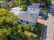 A beautiful home featuring mature landscaping, a brick driveway, and a modern roof in a residential neighborhood at 212 W Floribraska Ave, Tampa, FL 33603