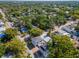 An aerial view showcasing the neighborhood with tree-lined streets and various styles of homes in a tranquil setting at 212 W Floribraska Ave, Tampa, FL 33603