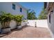 Paver patio backyard with privacy fence and lush tropical landscaping at 212 W Floribraska Ave, Tampa, FL 33603