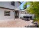Paver patio and backyard including a covered hot tub with steps at 212 W Floribraska Ave, Tampa, FL 33603
