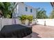 Backyard showcasing hot tub, paver patio, privacy fence and tropical plants at 212 W Floribraska Ave, Tampa, FL 33603