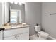 Bright bathroom featuring a granite countertop, white cabinets, and neutral wall color at 212 W Floribraska Ave, Tampa, FL 33603
