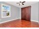 Bedroom with hardwood floors, closet and window overlooking the neighborhood at 212 W Floribraska Ave, Tampa, FL 33603