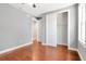 Bedroom with hardwood floors, open closet, neutral colors, and a ceiling fan at 212 W Floribraska Ave, Tampa, FL 33603