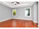 Spacious bedroom featuring hardwood floors, a tray ceiling, and large windows at 212 W Floribraska Ave, Tampa, FL 33603