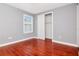 Neutral bedroom featuring hardwood floors, closet and a bright window overlooking the neighborhood at 212 W Floribraska Ave, Tampa, FL 33603