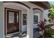 Covered front entry with decorative door, arched entryway, and small garden providing a welcoming curb appeal at 212 W Floribraska Ave, Tampa, FL 33603