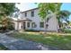 A two-story home showcases a well-manicured lawn with attractive landscaping, enhancing the property's curb appeal at 212 W Floribraska Ave, Tampa, FL 33603