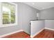Upstairs hallway with hardwood floors, gray walls and a large window allowing natural light at 212 W Floribraska Ave, Tampa, FL 33603