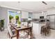 Eat-in kitchen featuring white cabinetry, modern stainless appliances and a glass door to the outside at 212 W Floribraska Ave, Tampa, FL 33603