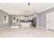 Bright kitchen with white cabinets, stainless steel appliances, granite countertops, and an island with elegant marble tile at 212 W Floribraska Ave, Tampa, FL 33603