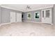 Spacious living room featuring gray walls, large windows, and elegant marble tile flooring, creating a modern design at 212 W Floribraska Ave, Tampa, FL 33603
