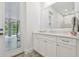 Bright bathroom with marble countertop, stylish vanity, and access to an outdoor patio at 2604 S Bryant Cir, Tampa, FL 33629