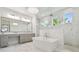Luxurious bathroom with a soaking tub, a walk-in shower, and dual vanities offers a spa-like experience at 2604 S Bryant Cir, Tampa, FL 33629