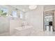 Luxurious bathroom with a freestanding tub, rainfall shower, and elegant marble finishes for a spa-like retreat at 2604 S Bryant Cir, Tampa, FL 33629