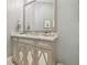 Elegant bathroom vanity with patterned doors, granite countertops, and modern fixtures at 2604 S Bryant Cir, Tampa, FL 33629