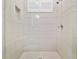 Modern shower with light tile, glass enclosure and a built-in niche for storage at 2604 S Bryant Cir, Tampa, FL 33629