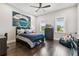 Cozy bedroom with hardwood floors, a ceiling fan, and a baseball themed decor creating a relaxing space at 2604 S Bryant Cir, Tampa, FL 33629