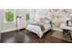 Charming bedroom featuring hardwood floors and a floral mural creating a cozy and stylish retreat at 2604 S Bryant Cir, Tampa, FL 33629