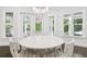 Bright dining nook featuring a modern chandelier, a round table, and multiple windows with wooded views at 2604 S Bryant Cir, Tampa, FL 33629